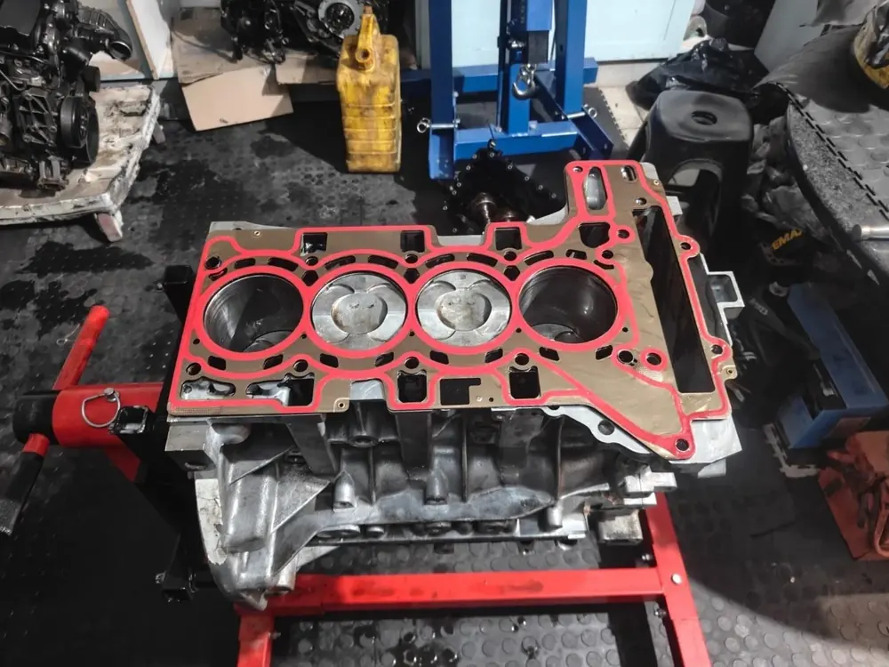 An engine block on a stand with a new head gasket